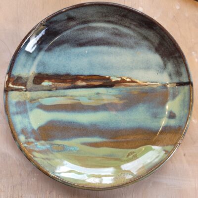 Plate with glazes showing a river landscape