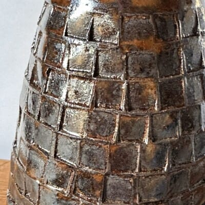 Close-up of Black patterned pot - Amber Topaz